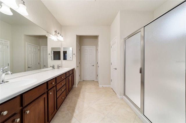 bathroom with tile patterned flooring, vanity, and walk in shower