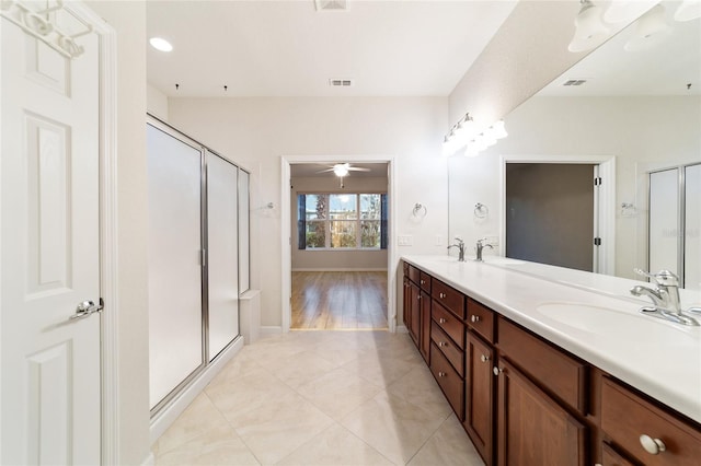 bathroom featuring ceiling fan, wood-type flooring, a shower with door, and vanity