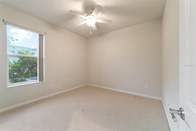 carpeted empty room featuring ceiling fan