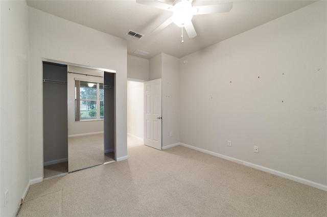 unfurnished bedroom featuring ceiling fan, a closet, and light carpet