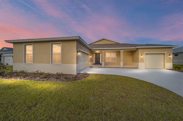 view of front of property featuring a yard and a garage