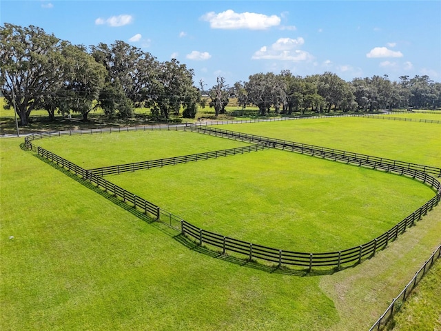 view of property's community with a yard and a rural view