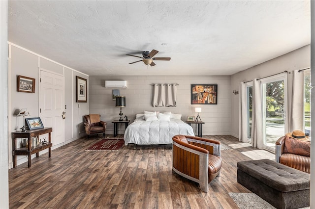 bedroom featuring ceiling fan, dark hardwood / wood-style flooring, a wall unit AC, a textured ceiling, and access to outside