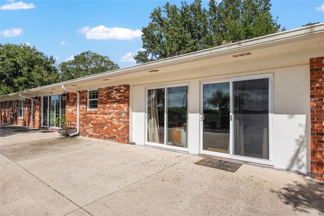 rear view of property featuring a patio area