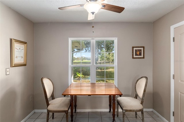 tiled dining space featuring ceiling fan