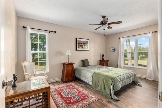 bedroom featuring a textured ceiling, hardwood / wood-style flooring, and ceiling fan