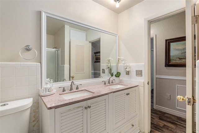 bathroom featuring vanity, toilet, tile walls, walk in shower, and wood-type flooring