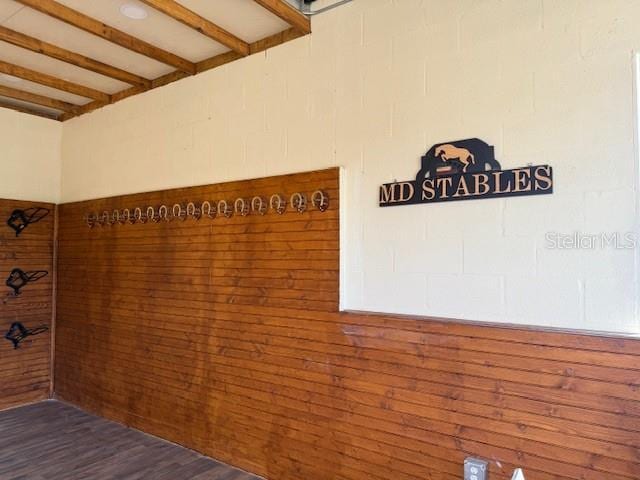 details featuring beam ceiling and hardwood / wood-style flooring