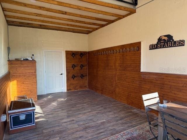 interior space featuring beamed ceiling and dark hardwood / wood-style flooring