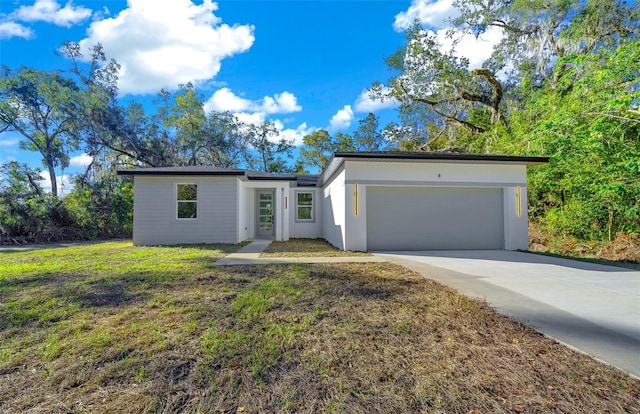 ranch-style home with a front yard and a garage