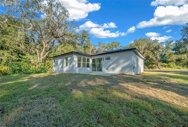 back of house with a yard