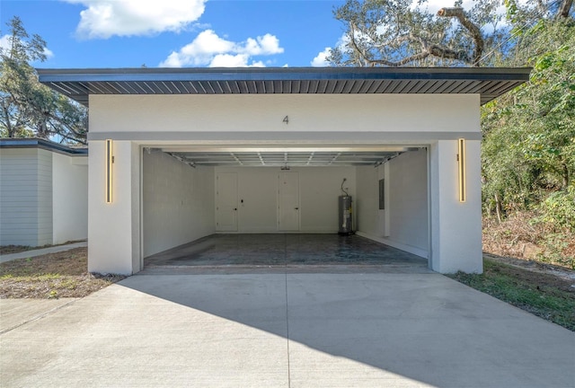 garage featuring gas water heater and a carport