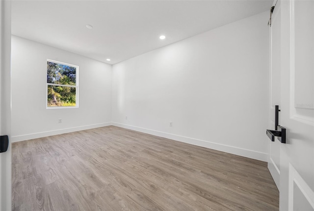 spare room featuring light hardwood / wood-style flooring