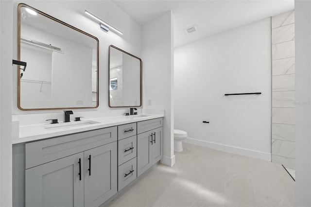 bathroom with tile patterned floors, vanity, and toilet