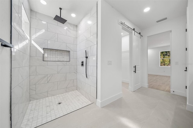 bathroom featuring tiled shower and tile patterned floors