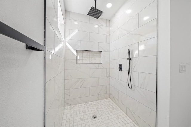 bathroom with a tile shower