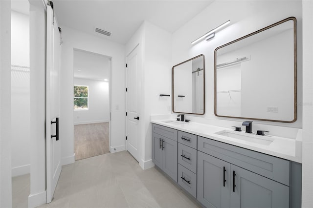 bathroom featuring tile patterned flooring and vanity