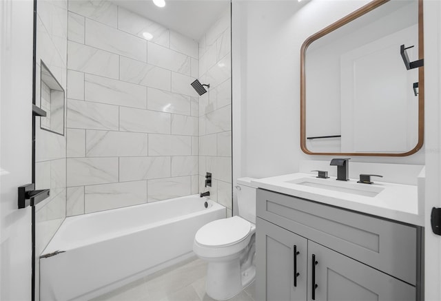 full bathroom featuring tile patterned flooring, toilet, vanity, and tiled shower / bath