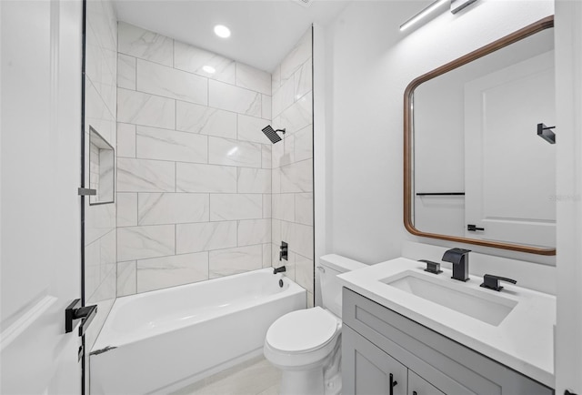 full bathroom featuring vanity, toilet, and tiled shower / bath