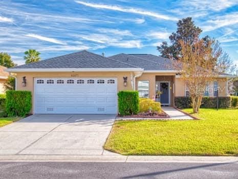 ranch-style home featuring a front yard and a garage