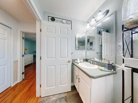 bathroom with hardwood / wood-style floors and vanity