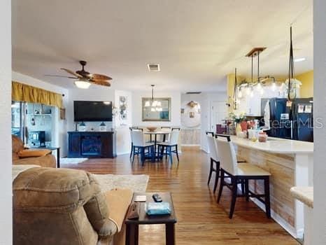 living room featuring hardwood / wood-style floors and ceiling fan