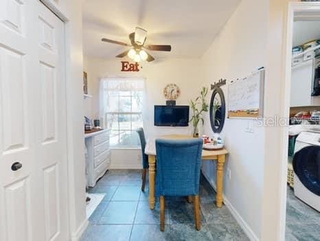 tiled office space with washer / clothes dryer and ceiling fan