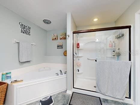 bathroom featuring plus walk in shower