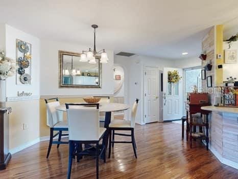 dining space with a chandelier and dark hardwood / wood-style flooring