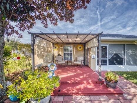 exterior space featuring a pergola and a sunroom