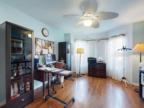 home office with hardwood / wood-style floors and ceiling fan