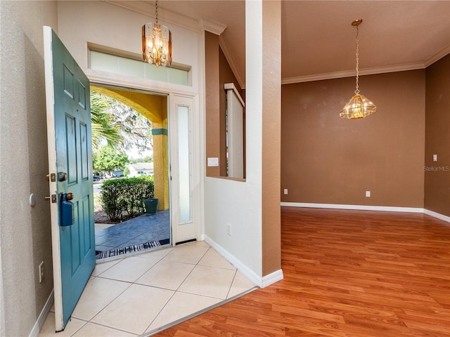 entryway featuring crown molding and light wood-type flooring