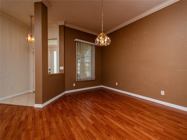 spare room featuring light hardwood / wood-style floors and ornamental molding