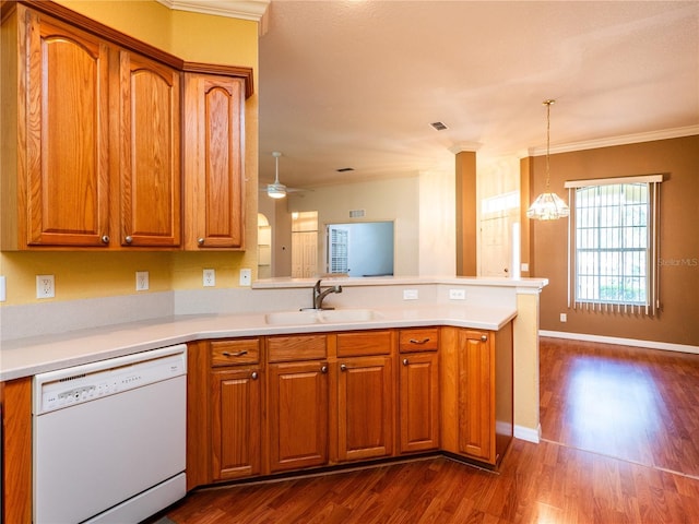 kitchen featuring dishwasher, crown molding, sink, dark hardwood / wood-style floors, and kitchen peninsula