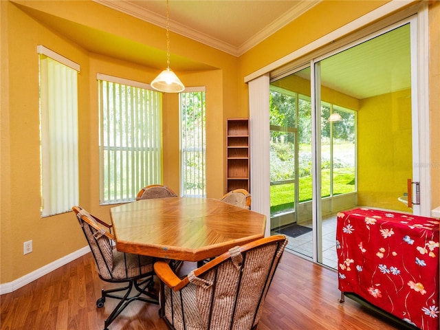 dining space featuring ornamental molding and hardwood / wood-style flooring