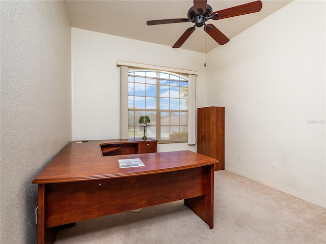 unfurnished office featuring ceiling fan, light carpet, and a textured ceiling