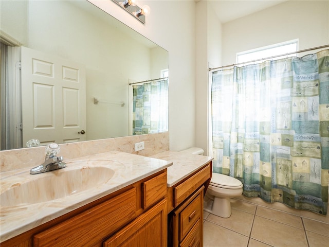 bathroom featuring tile patterned flooring, vanity, and toilet