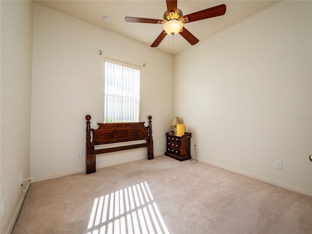 spare room featuring ceiling fan and light carpet