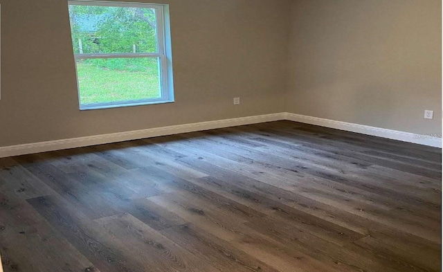 spare room featuring dark hardwood / wood-style floors