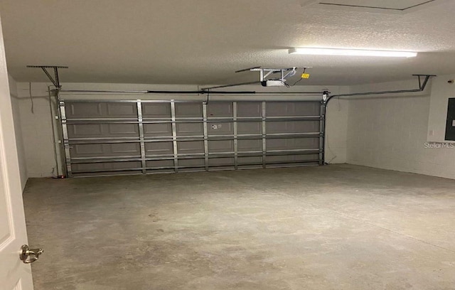 garage featuring electric panel and a garage door opener