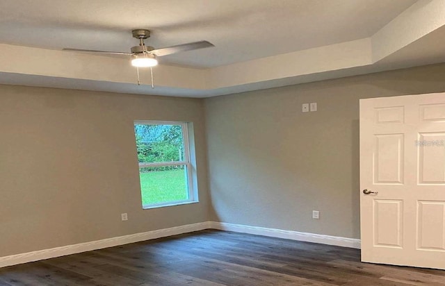 spare room with dark hardwood / wood-style floors and ceiling fan