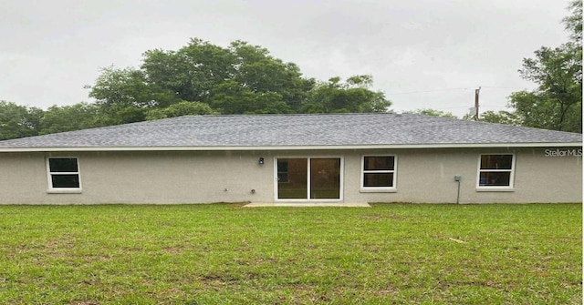 rear view of house with a lawn