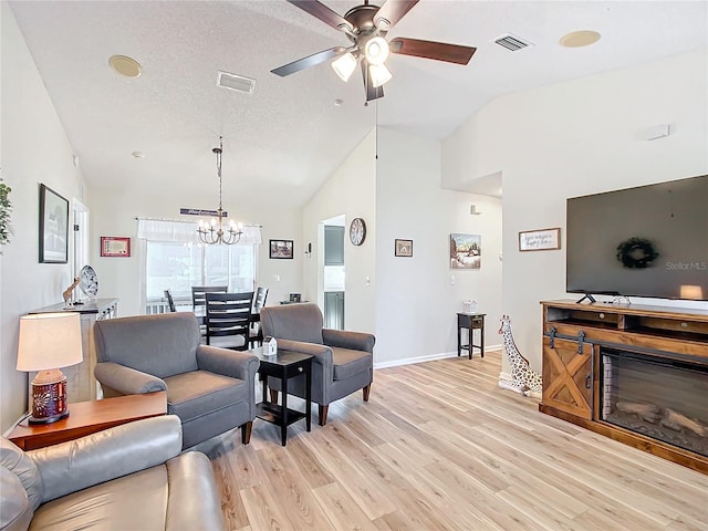 living room featuring a textured ceiling, ceiling fan with notable chandelier, high vaulted ceiling, and light hardwood / wood-style flooring