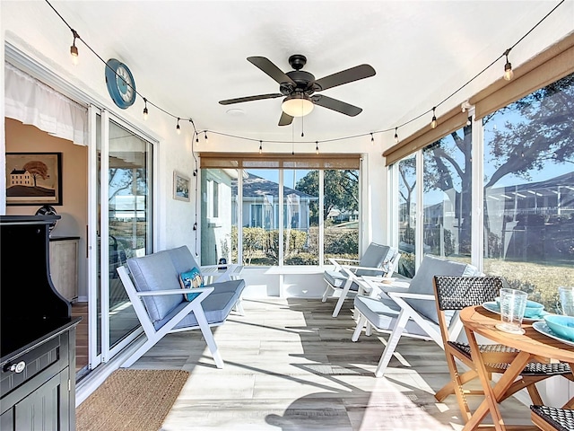 sunroom with a wealth of natural light and ceiling fan