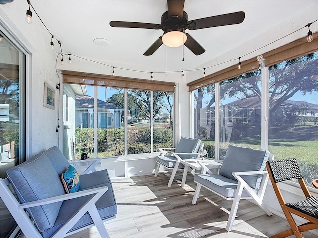 sunroom / solarium featuring ceiling fan