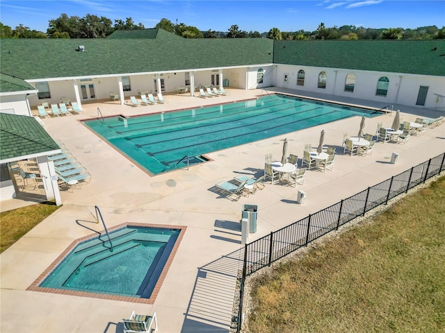 view of pool featuring a community hot tub and a patio