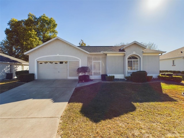 ranch-style house featuring a garage and a front yard