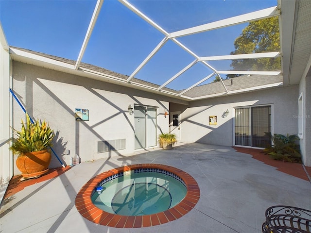 view of pool featuring a lanai, an in ground hot tub, and a patio