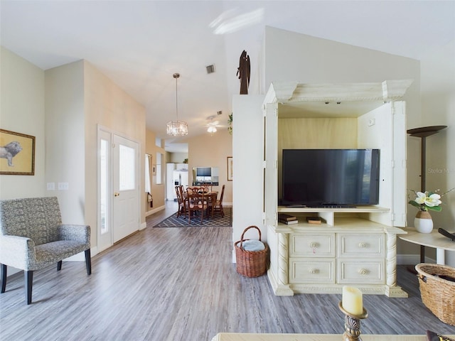 living room featuring light hardwood / wood-style floors and lofted ceiling