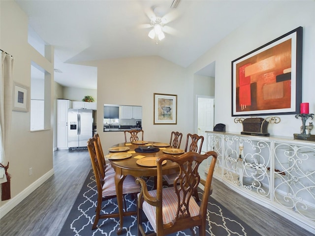 dining area with dark hardwood / wood-style floors, ceiling fan, and lofted ceiling